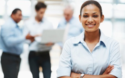 smiling female executive with colleagues at the back picture